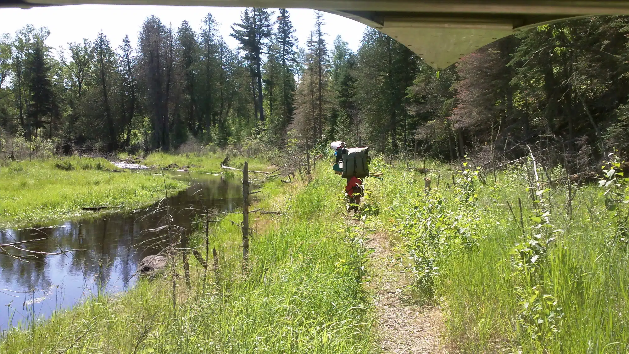 Under The Canoe Carrying It Solo On A Portage