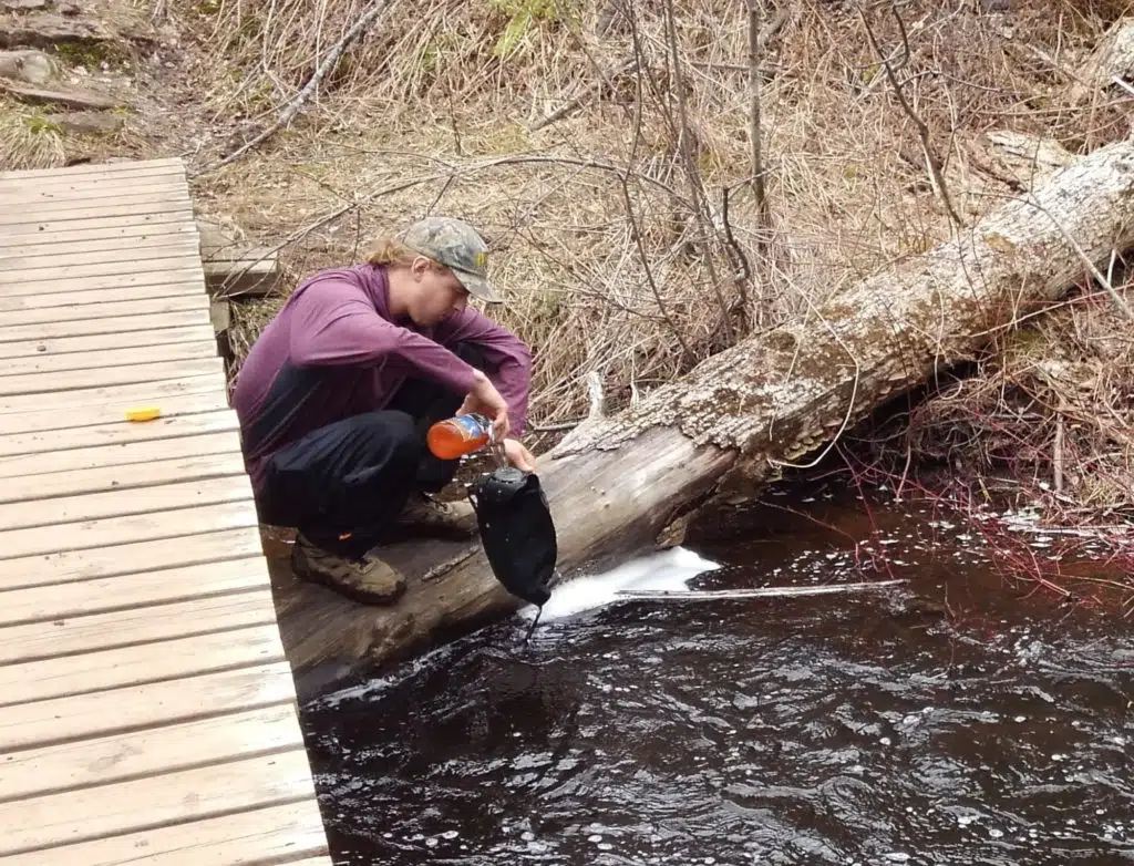 10 Top Pieces of Backpacking Gear You NEED To Start With Right Now 4 Getting Water Out Of The River To Filter
